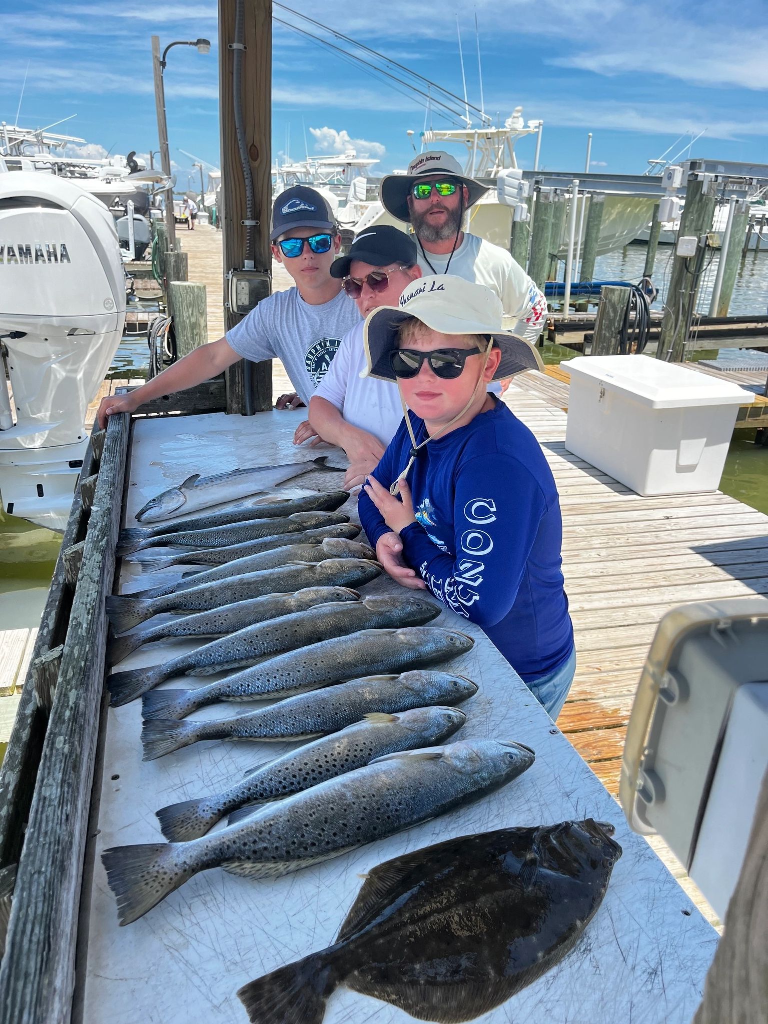 Group displaying fresh catch of fish